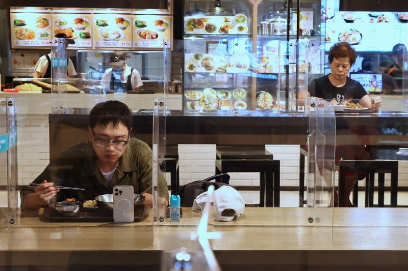 People eat lunch between plastic partitions following the outbreak of coronavirus disease (COVID-19), in Taipei,