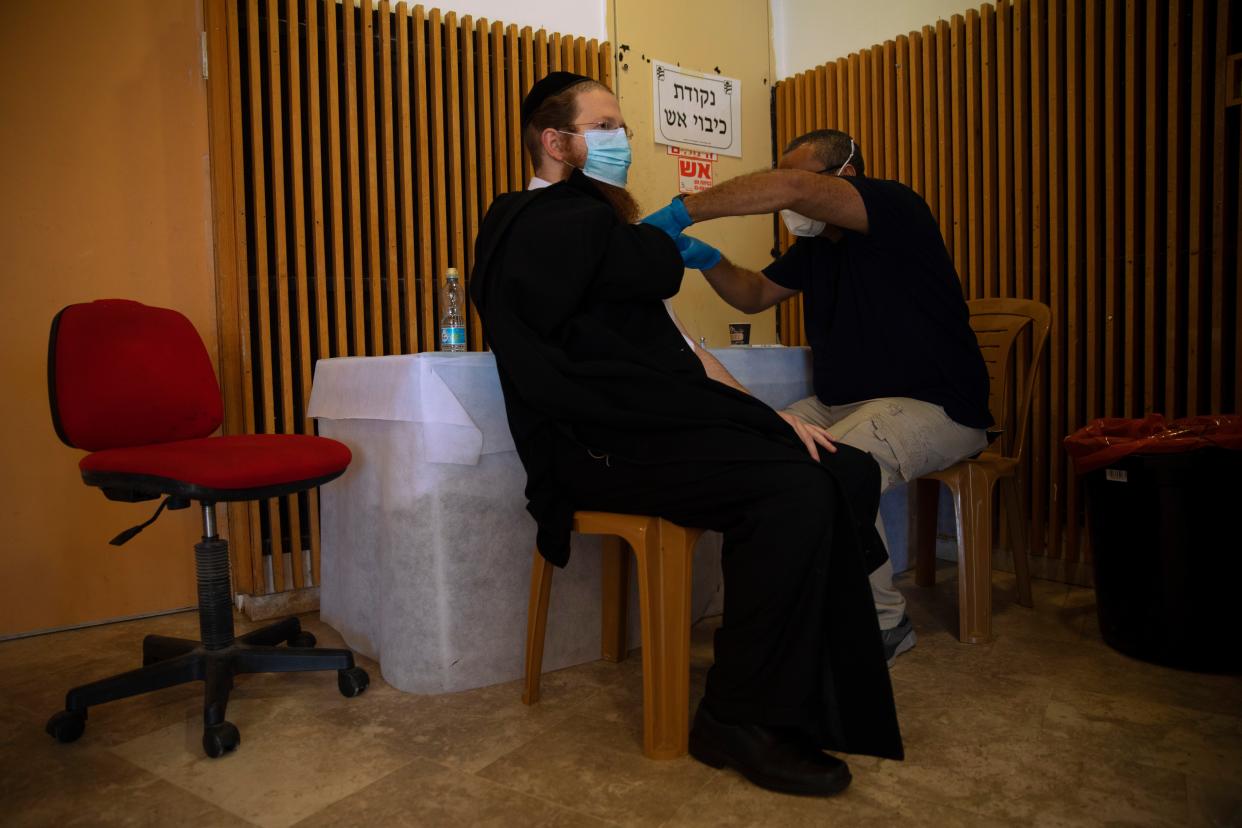 An ultra-Orthodox Jewish man receives a Pfizer-BioNTech coronavirus vaccine at a COVID-19 vaccination center in the West Bank Jewish settlement of Givat Zeev, near Jerusalem, Monday, Feb. 1, 2021.