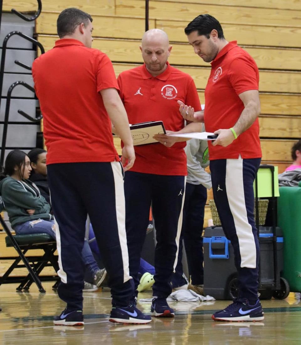 Central Bucks East head coach Erik Henrysen, center, consults with his assistants during one of the Patriots' 24 wins this season.