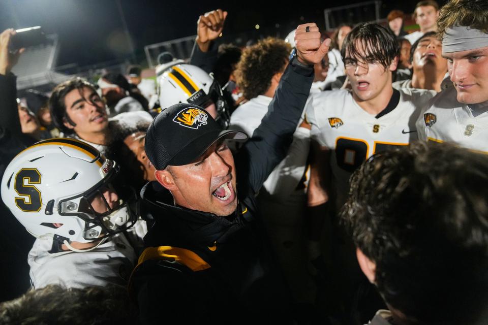 Saguaro head coach Jason Mohns, at center, celebrates with his team after they scored a two-point conversion to win the game 43-42 during the Open Division semifinal between Liberty and Saguaro at Mountain Ridge High School on Saturday, Dec. 3, 2022, in Glendale.