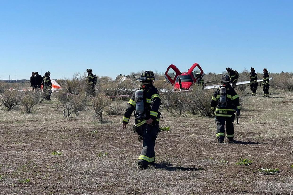 <p>In this photo provided by South Metro Fire Rescue, emergency personnel work at the scene where a single engine plane landed after a mid-air collision near Denver, Wednesday, 12 May 2021. Federal officials say two airplanes collided but that there are no injuries</p> (AP)