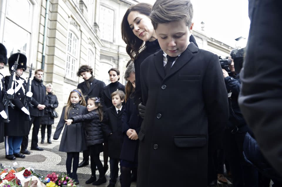 Princess Mary and Prince Christian look over floral tributes to Prince Henrik. Photo: Getty Images