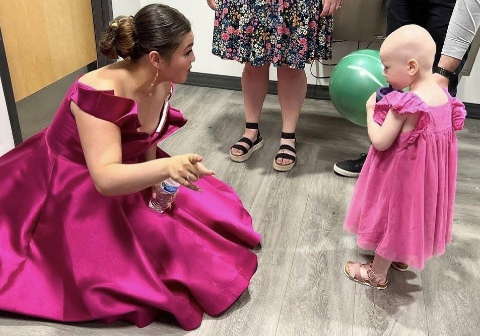 Cancer survivor Molly Oldham with young Scout at the Gratitude Gala July 23 in Fairlawn.