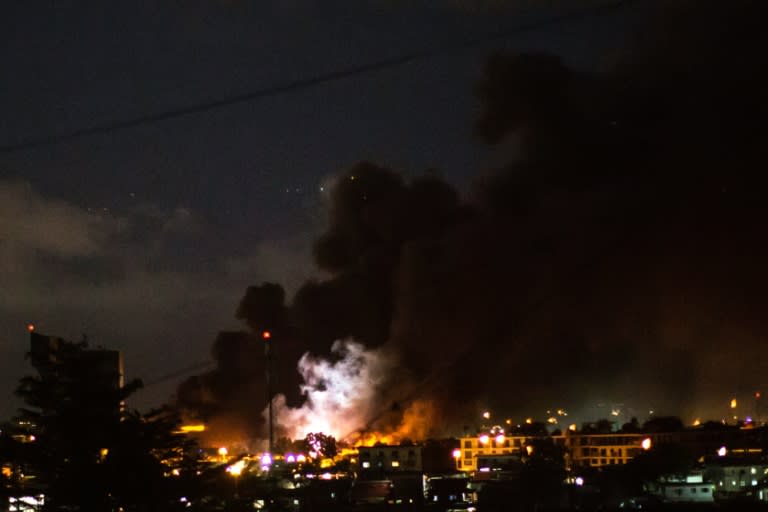 The flash of an explosion amid flames and smoke billowing from the National Assembly building in Libreville after it was set ablaze on August 31, 2016 by demonstrators protesting after Gabon's president Ali Bongo's re-election