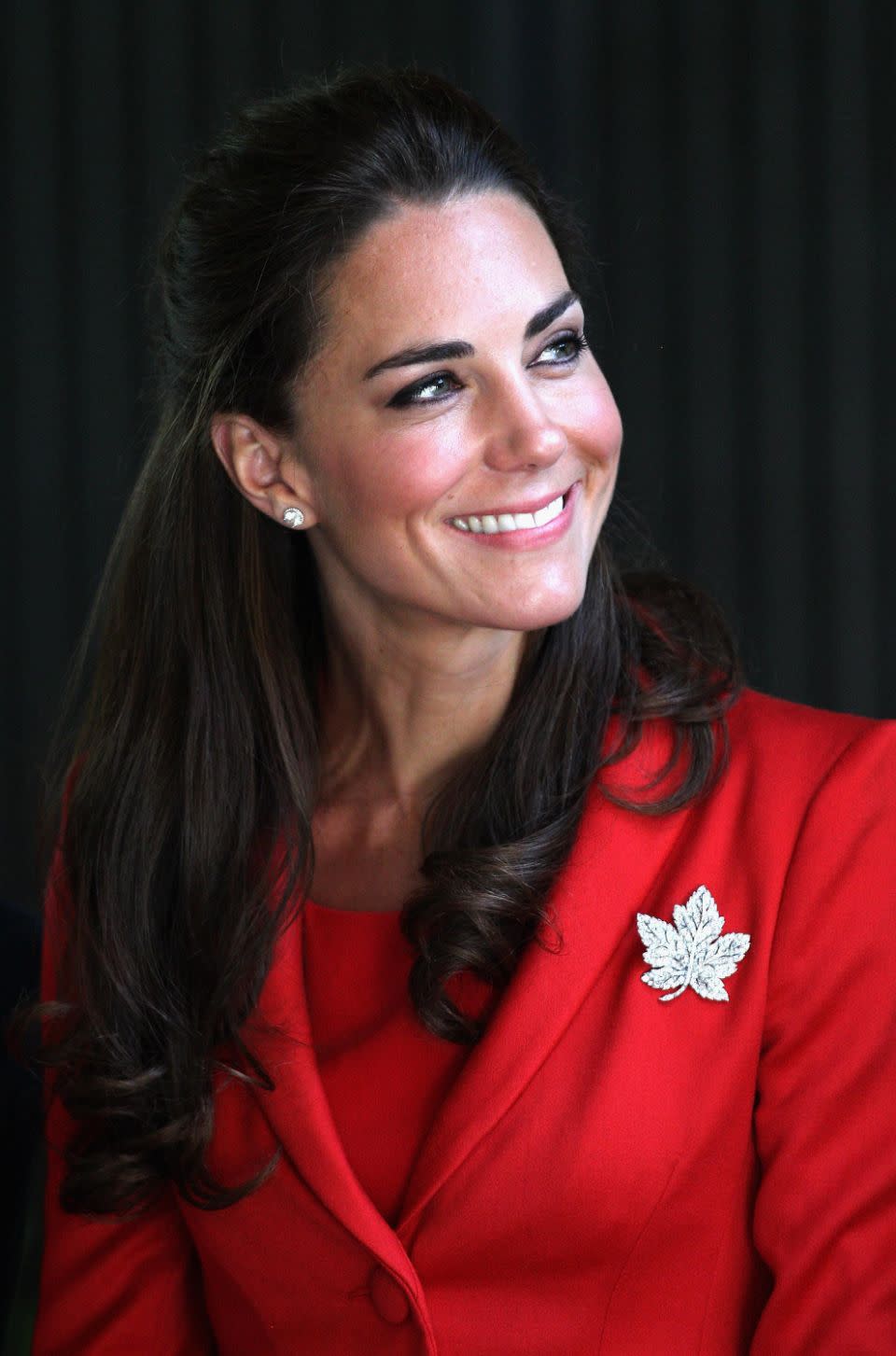 Kate on a visit to Canada wearing red and with a pin. Photo: Getty