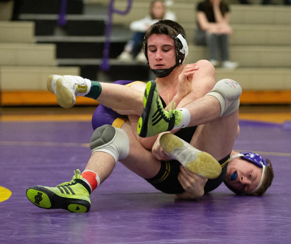Austin McBurney of Perry and Austin Felts of Jackson wrestle in the 132-pound match Wednesday at Jackson.