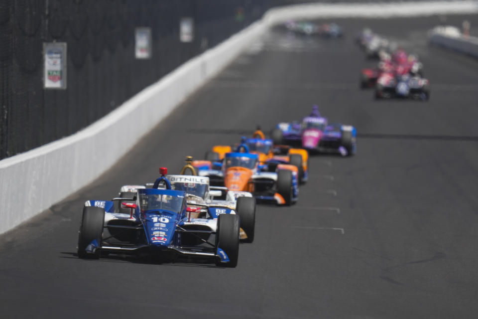 Alex Palou, of Spain, leads a pack as they head into the first turn during the final practice for the Indianapolis 500 auto race at Indianapolis Motor Speedway in Indianapolis, Friday, May 26, 2023. (AP Photo/Michael Conroy)