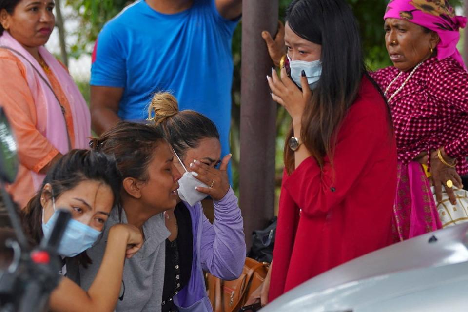 Family members and relatives of passengers on board the Twin Otter aircraft operated by Tara Air weep outside the airport in Pokhara on 29 May (AFP via Getty Images/Yunish Gurung)