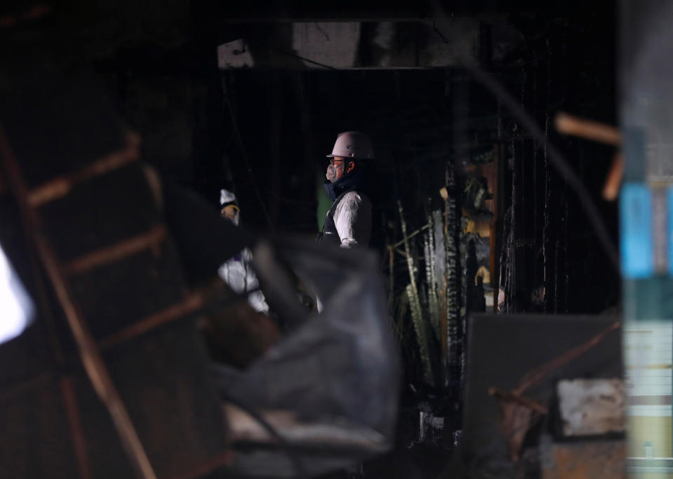 <p>A police investigator examines a burnt hospital in Miryang, South Korea, Jan. 26, 2018. (Photo: Kim Hong-ji/Reuters) </p>