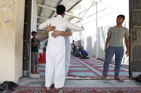 A volunteer searches a man as he arrives for Friday prayers at a Shi'ite mosque in the village of Diraz west of Manama, July 3, 2015. REUTERS/Hamad I Mohammed