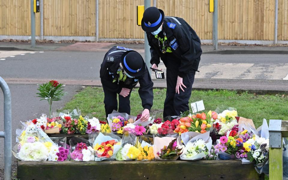Community police officers lay flowers to the tributes in the village of Marston Moretaine,  - Justin Tallis/AFP