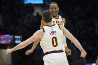 Cleveland Cavaliers' Isaac Okoro, right, and Kevin Love celebrate in the second half of an NBA basketball game against the New York Knicks, Monday, Jan. 24, 2022, in Cleveland. (AP Photo/Tony Dejak)