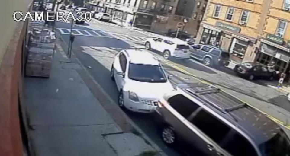 A screenshot of security footage showing the moment an out-of-control driver slammed into a parked car and struck an unsuspecting mum crossing the street with her 8-month-old. Source: Yonkers Police Department 