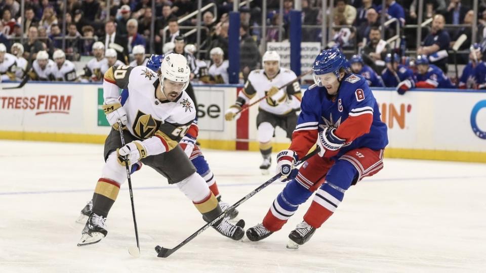 Jan 27, 2023; New York, New York, USA; Vegas Golden Knights center Chandler Stephenson (20) and New York Rangers defenseman Jacob Trouba (8) battle for control of the puck in the first period at Madison Square Garden.