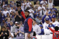 Atlanta Braves relief pitcher and former Dodger Kenley Jansen, left, acknowledges the crowd while being honored with gifts frim his former teammates Los Angeles Dodgers manager Dave Roberts, third from right, and third baseman Justin Turner, second from right, prior to a baseball game Monday, April 18, 2022, in Los Angeles. (AP Photo/Mark J. Terrill)