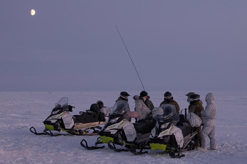 Air Force airmen exercise with snow mobiles in Alaska Arctic