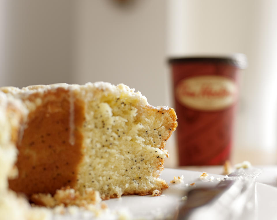 "Milton, Canada - June 26, 2011: Lemon poppyseed loaf with blurred but recognizable Tim Horton's coffee cup in the background. Tim Horton's is a popular Canadian food establishment and is often used colloquially as a symbol of Canada."