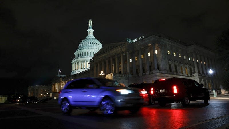 Cars drive pass the U.S. Capitol Building during a vote on a continuing resolution to fund the government on September 30, 2023 in Washington, DC.