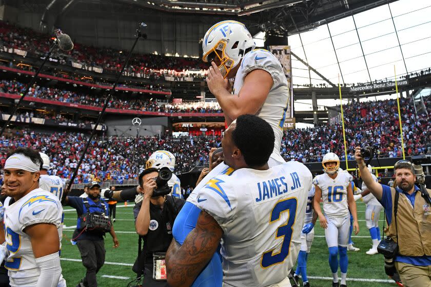 ATLANTA, GEORGIA - NOVEMBER 06: Cameron Dicker #15 of the Los Angeles Chargers celebrates after kicking the game winning field goal during the fourth quarter in the game against the Atlanta Falcons at Mercedes-Benz Stadium on November 06, 2022 in Atlanta, Georgia. (Photo by Adam Hagy/Getty Images)