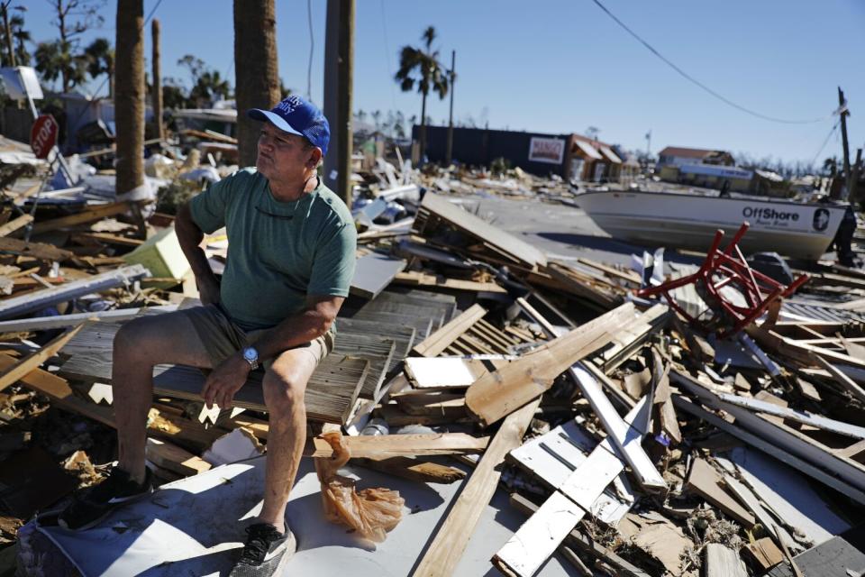 Hector Morales sits on a debris pile near his home which was destroyed by Hurricane Michael .