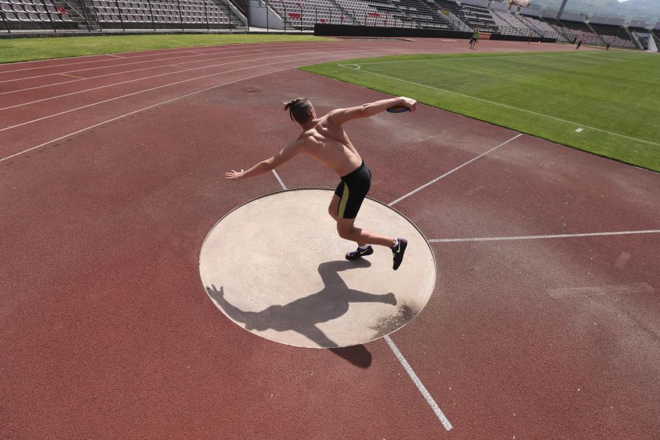 Ukrainian athlete Oleksander Titarenko, 17, practices during a training session at Elbasan Arena stadium in Elbasan, 45 kilometers (30 miles) south of Tirana, Albania, Monday, May 9, 2022. After fleeing from a war zone, a group of young Ukrainian track and field athletes have made their way to safety in Albania. Their minds are still between the two countries. (AP Photo/Franc Zhurda)