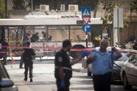 TEL AVIV, ISRAEL- NOVEMBER 21: Emergency services at the scene of an explosion on a bus with passengers onboard on November 21, 2012 in central Tel Aviv, Israel. At least ten people have been injured in a blast on a bus near military headquarters in what is being described as terrorist attack which threatens to derail ongoing cease-fire negotiations between Israeli and Palestinian authorities. (Photo by Ziv Oren/Getty Images)