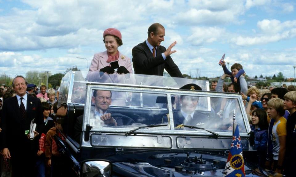 The Queen and Prince Philip wave from their open car in October 1981 in Wellington, New Zealand. 