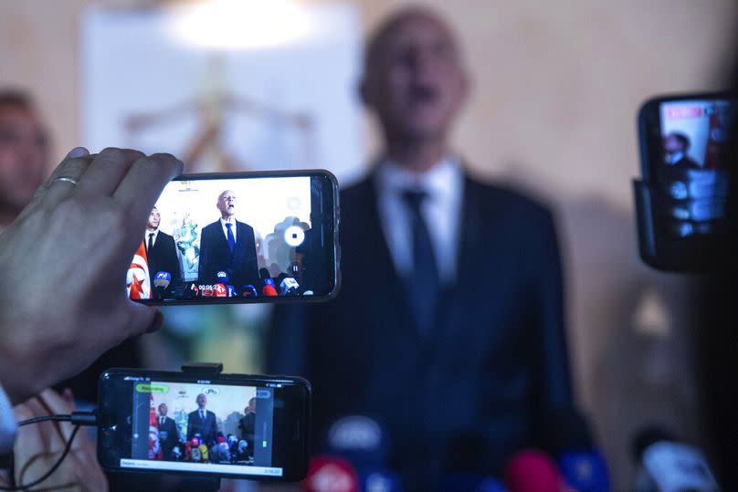 Reporters use cell phones as Tunisia's Kais Saied speaks in Tunis, October 2019