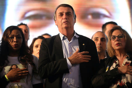 FILE PHOTO: Presidential candidate Jair Bolsonaro listens to the national anthem during a meeting with women in Porto Alegre, Brazil August 30, 2018. REUTERS/Diego Vara/File Photo