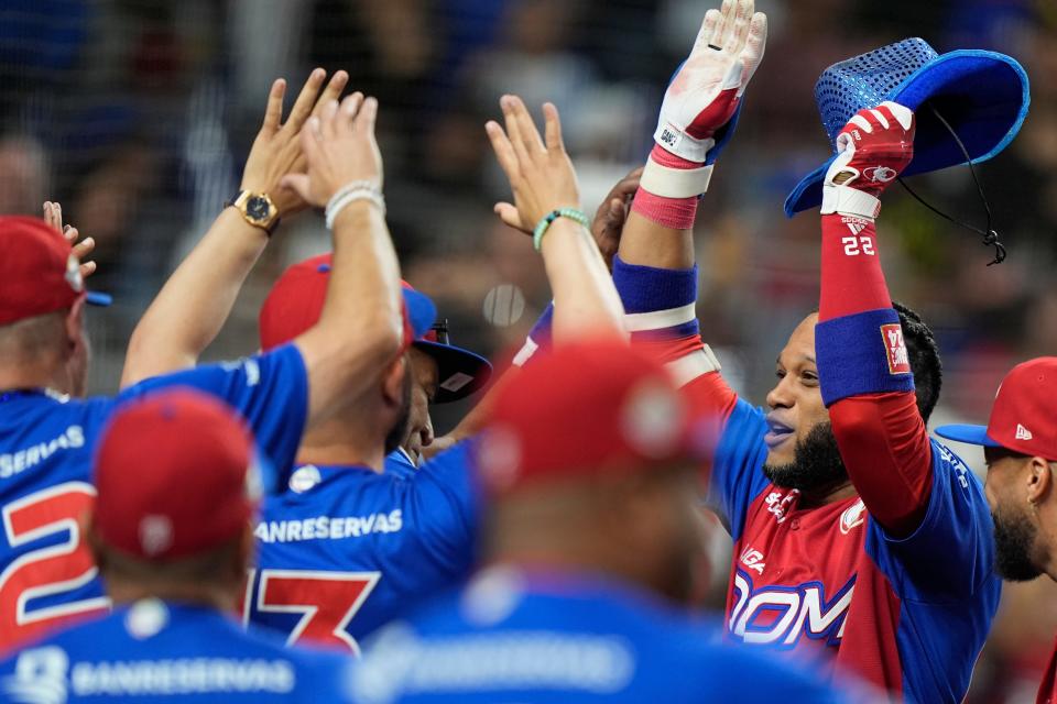 Dominican Republic's Robinson Cano, right, celebrates after a home run in the Caribbean Series.