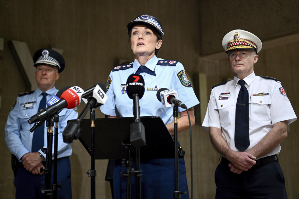 New South Wales Commissioner Karen Webb, center, addresses a press conference in Sydney, Tuesday, April 16, 2024, with Police Deputy Commissioner Peter Thurtell, left, and New South Wales Ambulance Commissioner Dr Dominic Morgan, right, following a knife attack that wounded a bishop during a church service on Monday. Webb said the suspect's comments pointed to a religious motive for the attack and is being treated as an act of terrorism. (Bianca De Marchi/AAP Image via AP)