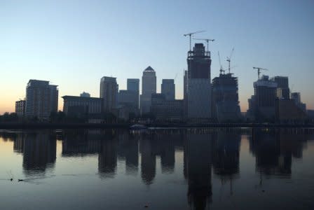 The Canary Wharf financial district is reflected in the river Thames on a sunny morning in London, Britain, May 8, 2018. REUTERS/Hannah McKay