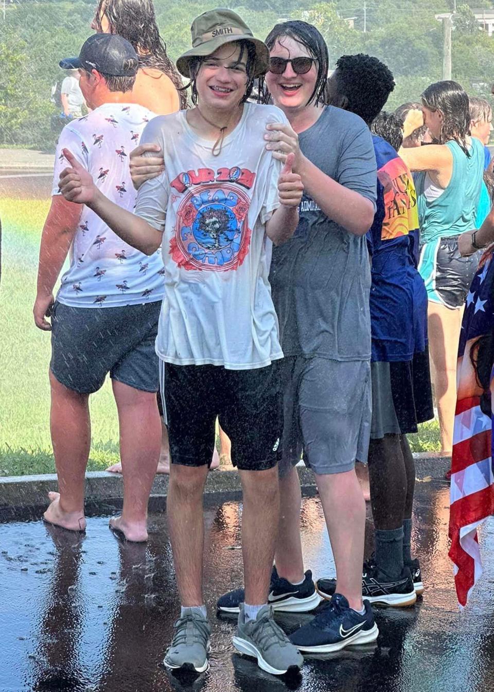 Jackson Smith and Aidan Johnson end the day at Farragut High School Marching Admirals band camp with a refreshing “rain” shower provided by Rural Metro Fire Department at the school Thursday, July 27, 2023.