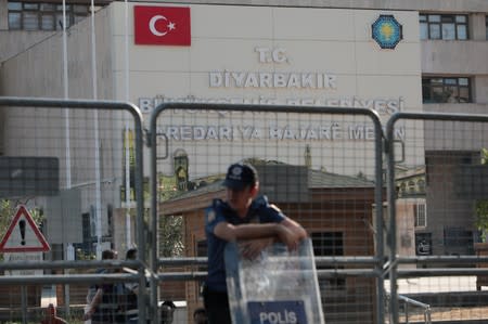 Turkish police stand guard in front of the Metropolitan Municipality headquarters in Diyarbakir