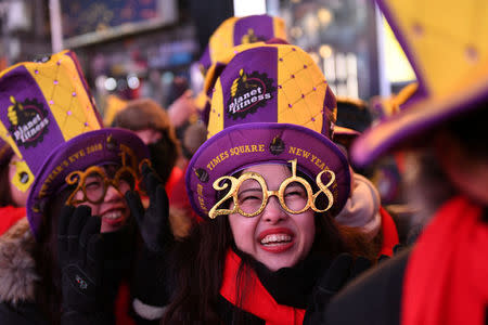 Revelers brace freezing cold temperatures in Times Square ahead of New Year's celebrations in Manhattan, New York, U.S., December 31, 2017. REUTERS/Darren Ornitz