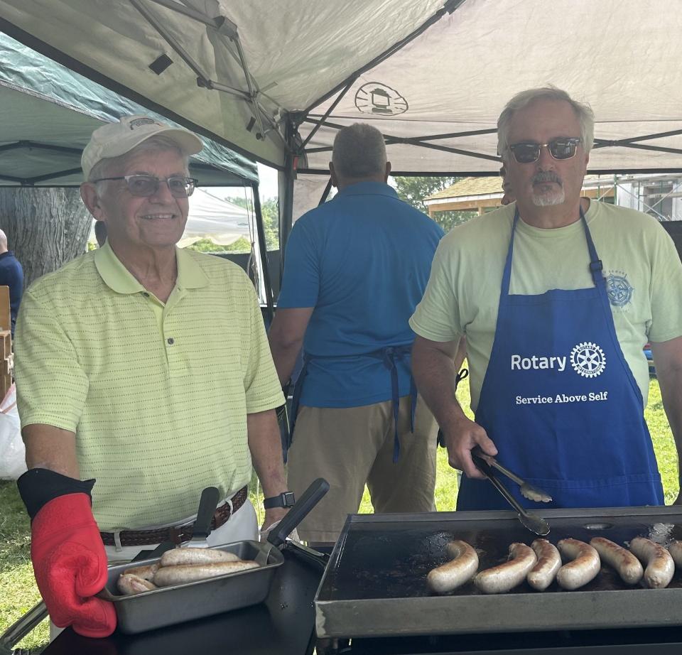 Rotary members Bob Krampf and Rich Warfield serve up food in the Biergarten.