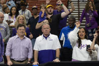 LSU football coach Brain Kelly, front center, stands with fans after LSU defeated Utah in a Sweet 16 college basketball game in the women's NCAA Tournament in Greenville, S.C., Friday, March 24, 2023. (AP Photo/Mic Smith)