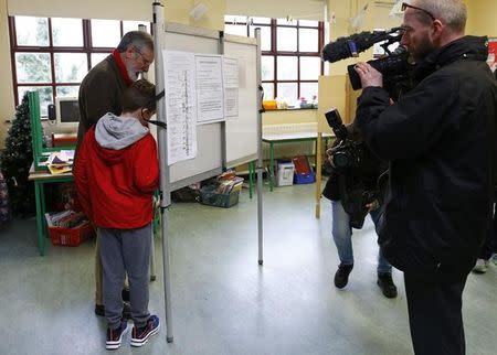 Leader of Sinn Fein Gerry Adams (L) casts his vote for the general election in Ravensdale near Dundalk, Ireland February 26, 2016. REUTERS/Darren Staples