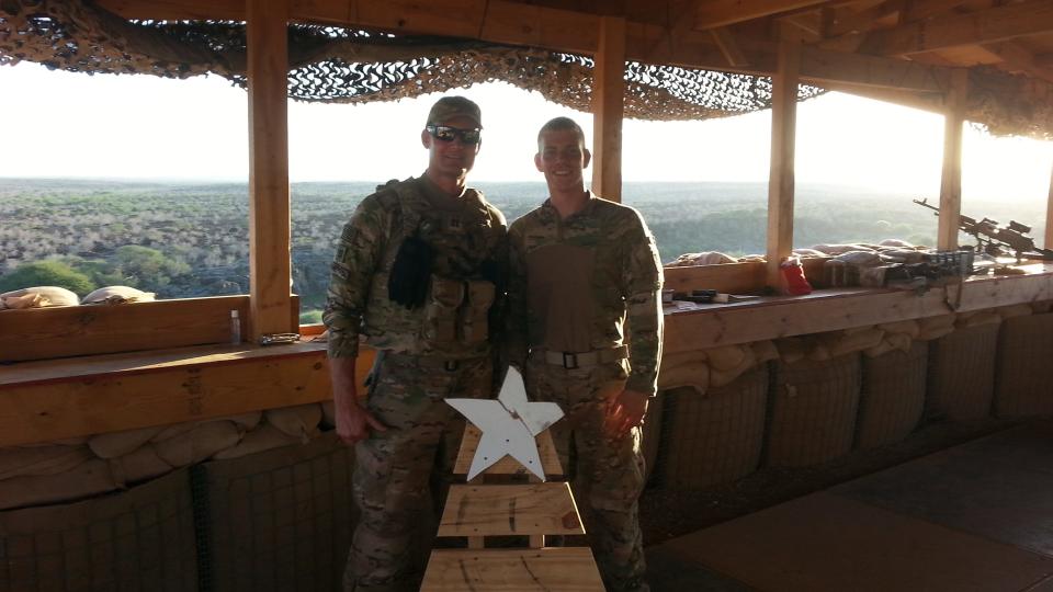 Lance Neff, left, poses with a soldier on Thanksgiving in 2016 at an airfield in Djibouti.