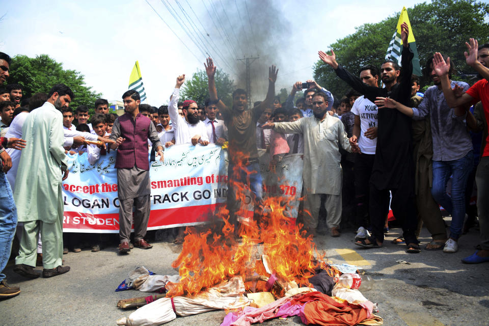 Pakistani Kashmiris burn effigies of Indian leaders at a protest in Muzaffarabad, Pakistan, capital of Pakistani Kashmir, Friday, Aug. 9, 2019. Islamabad said it would downgrade its diplomatic ties with New Delhi, expel the Indian ambassador and suspend trade. Prime Minister Imran Khan told Pakistan's National Security Committee that his government will use all diplomatic channels "to expose the brutal Indian racist regime" and human rights violations in Kashmir, the government's statement said. (AP Photo/M.D. Mughal)