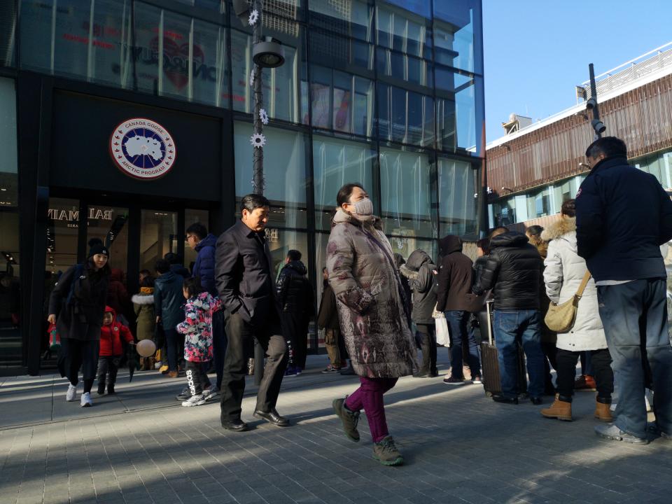 BEIJING, CHINA - DECEMBER 30: People line up to enter a Canada Goose flagship store at Sanlitun on December 30, 2018 in Beijing, China. Canada Goose opened its first flagship store in Beijing on Sunday. (Photo by Visual China Group via Getty Images/Visual China Group via Getty Images)