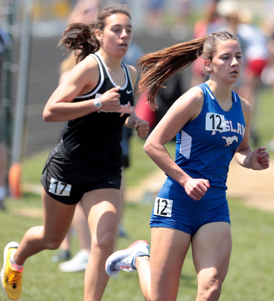 Tuslaw's Malena Cybak is on her way to winning the 800 meter run followed closely by Marlington's Stella Blake at the Stark County Track and Field Championships held at Perry High School Saturday, April 23, 2022.