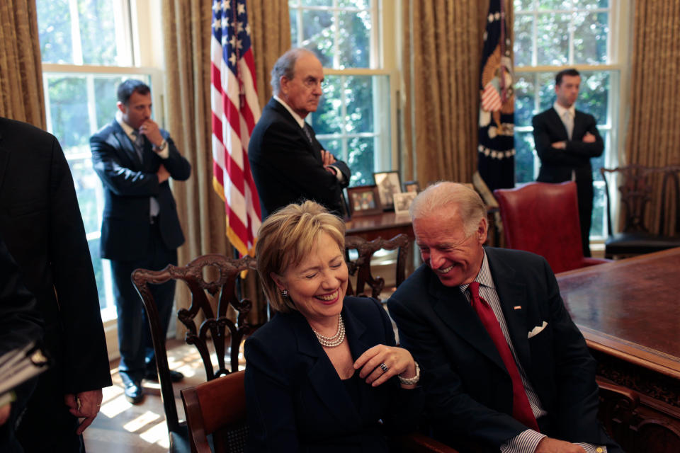 Secretary of State Hillary Clinton laughs at a remark by Vice President Joe Biden as they wait for the start of a press statement by President Barack Obama and Egyptian President Hosni Mubarak in the Oval Office Aug. 18, 2009. (Official White House Photo by Lawrence Jackson)  This official White House photograph is being made available only for publication by news organizations and/or for personal use printing by the subject(s) of the photograph. The photograph may not be manipulated in any way and may not be used in commercial or political materials, advertisements, emails, products, or promotions that in any way suggests approval or endorsement of the President, the First Family, or the White House. 