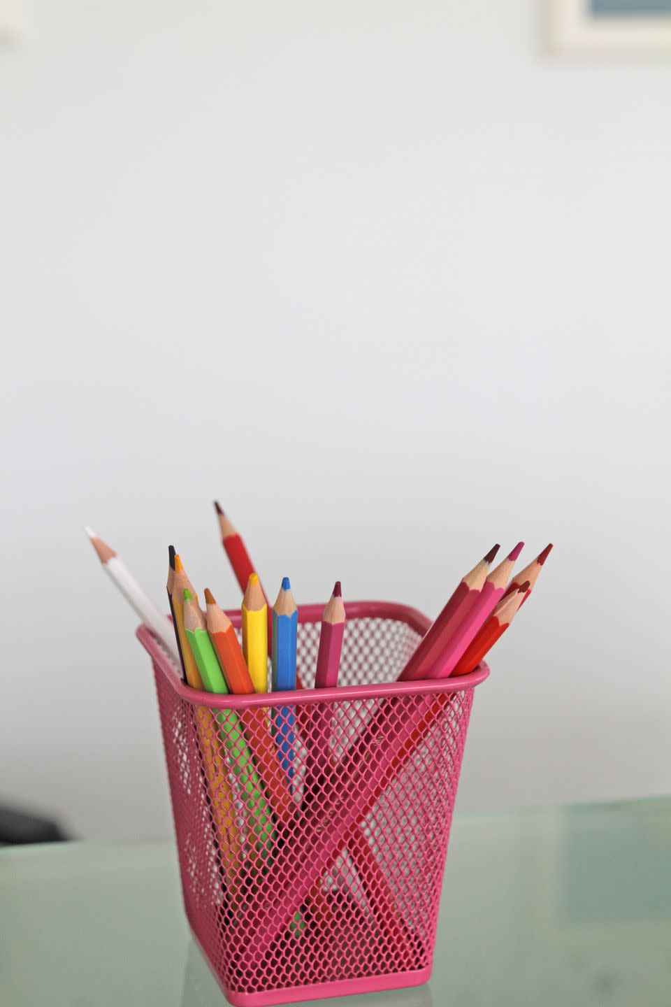 <p>Bring a tub of crayons or colored pencils to work, and use them to swap out every other grownup utensil around the office until there’s nary a pen or pencil left for serious tasks.</p>