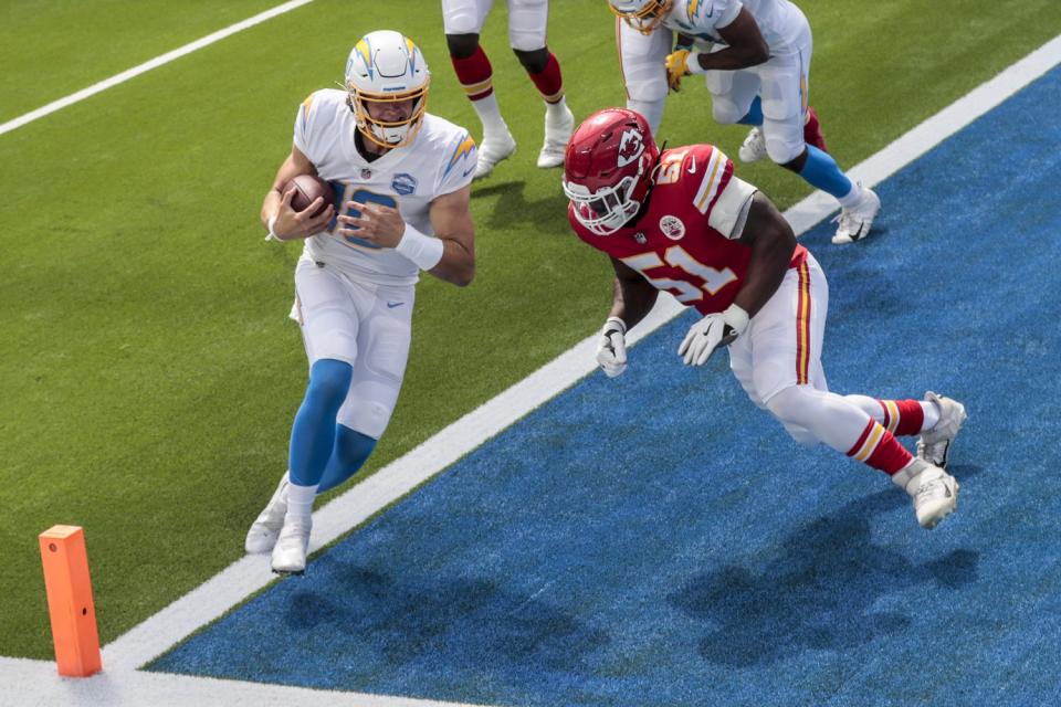 Chargers quarterback Justin Herbert is hit by Chiefs defensive end Mike Danna.