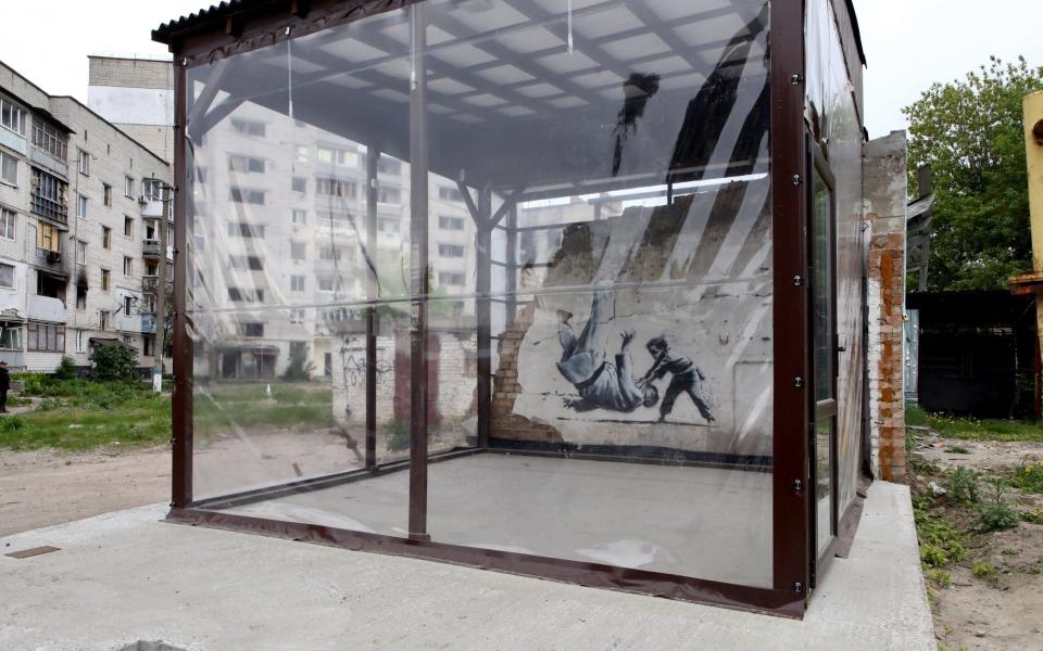 An artwork by Banksy that features a boy defeating an adult man in judo sparring which had been on the wall of a destroyed building in Borodianka has been put inside a shockproof display - Ukrinform/Shutterstock/Shutterstock