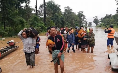 People evacuating flooded villages. Many have attempted to board safety boats to take them to safe areas 