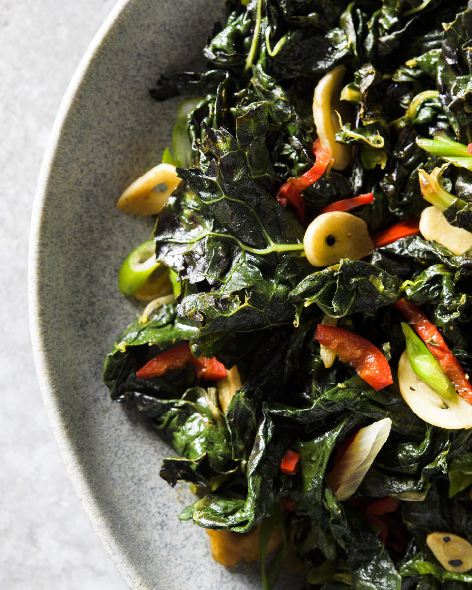 This image released by Milk Street shows a recipe for charred kale with garlic, chilies and lime. (Milk Street via AP)