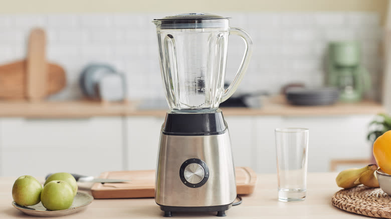 Blender on counter with fruits