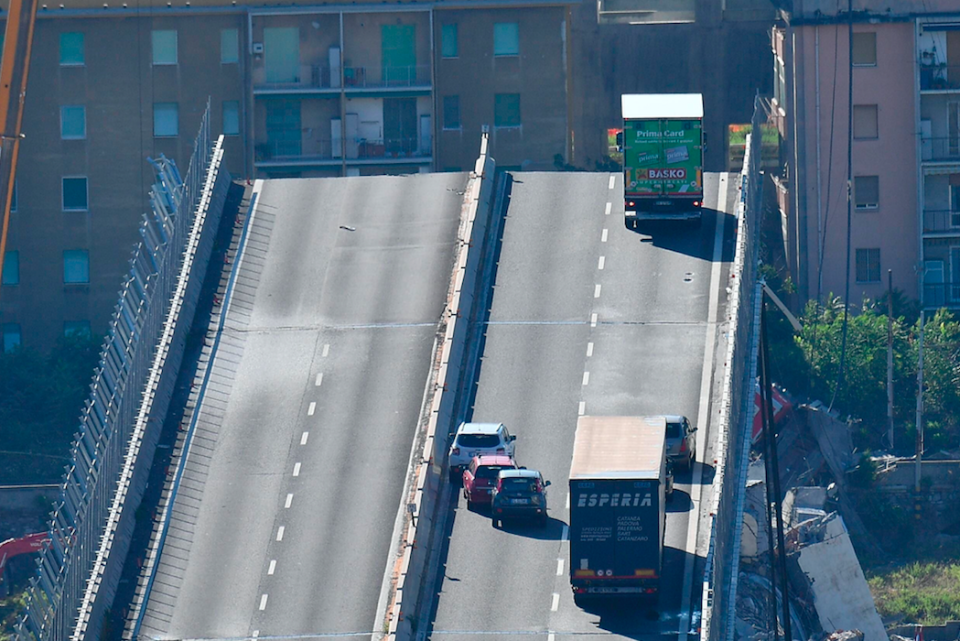 <em>The green truck could be seen sitting precariously at the edge of where the bridge collapsed (AP)</em>